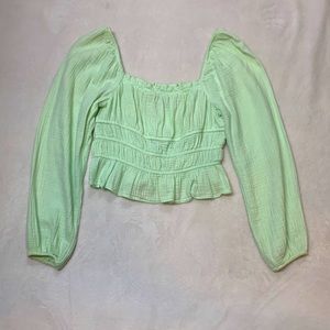 A small beautiful mint colored top in the size small. The brand is Wild Fable.